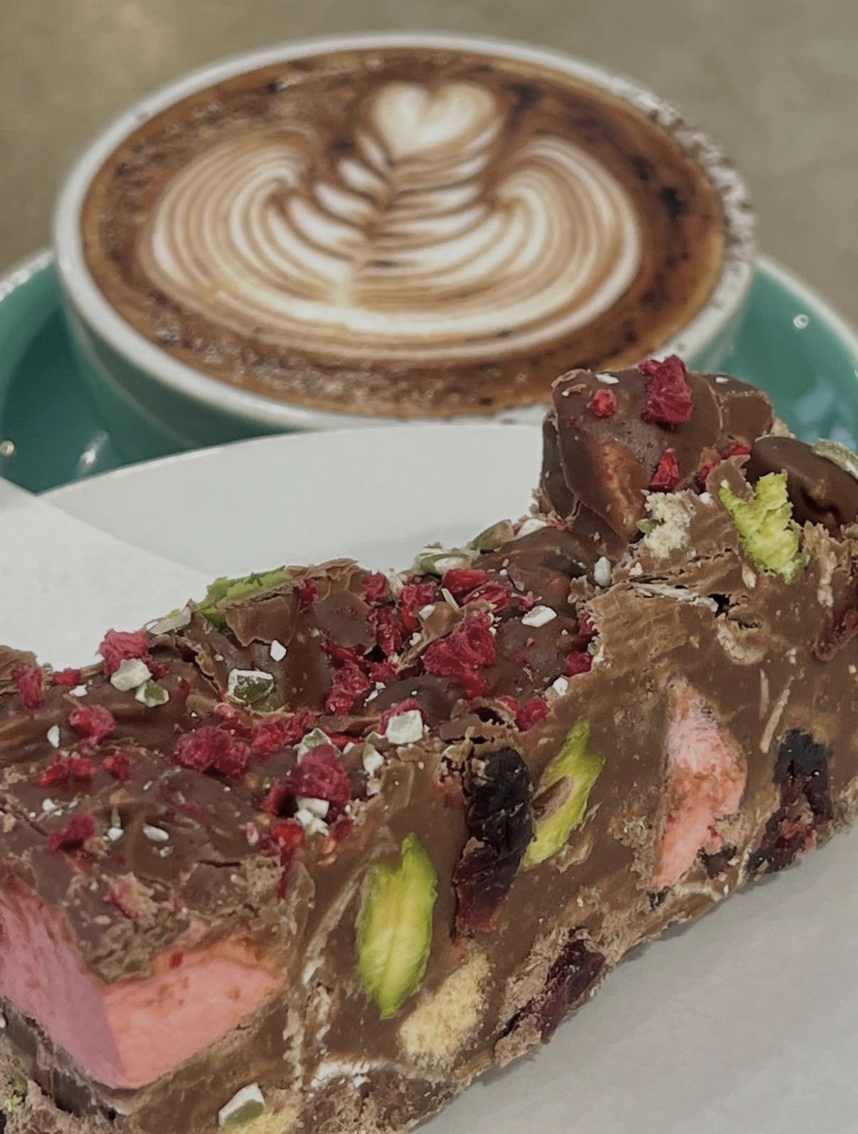 Slab of rocky road with pistachio, raspberry and marshmallow
